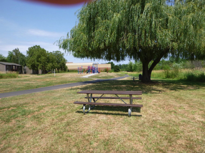Picnic table in the sun and shade near a playground